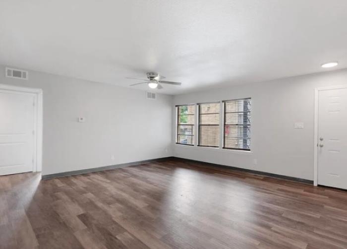 1283 East Raines Road Memphis, TN 38116 - Photo 3 of 23 wooden floor in an empty room with a window