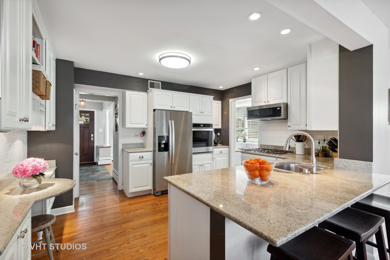 700 Juniper Road Glenview, IL 60025 - Photo 13 of 34 a kitchen with stainless steel appliances granite countertop a sink refrigerator and microwave