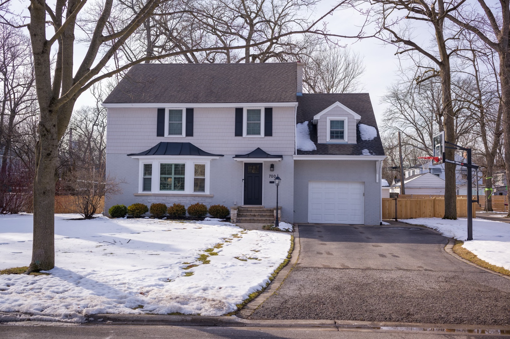 700 Juniper Road Glenview, IL 60025 - Photo 29 of 34 a front view of a house with a yard covered in snow