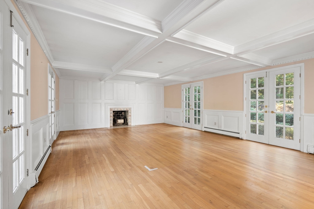91 Glen Street Natick, MA 01760 - Photo 11 of 39 a view of an empty room with wooden floor and a window