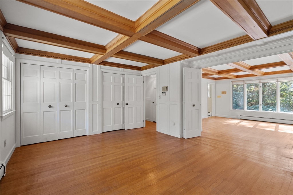 91 Glen Street Natick, MA 01760 - Photo 13 of 39 a view of empty room with wooden floor and fan