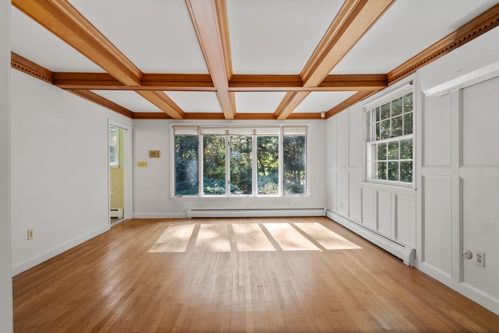 91 Glen Street Natick, MA 01760 - Photo 14 of 39 a view of an empty room with wooden floor and a window
