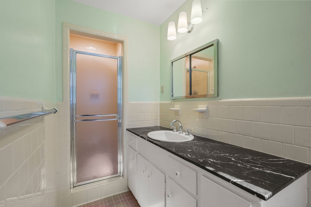 91 Glen Street Natick, MA 01760 - Photo 16 of 39 a bathroom with a sink a toilet and shower
