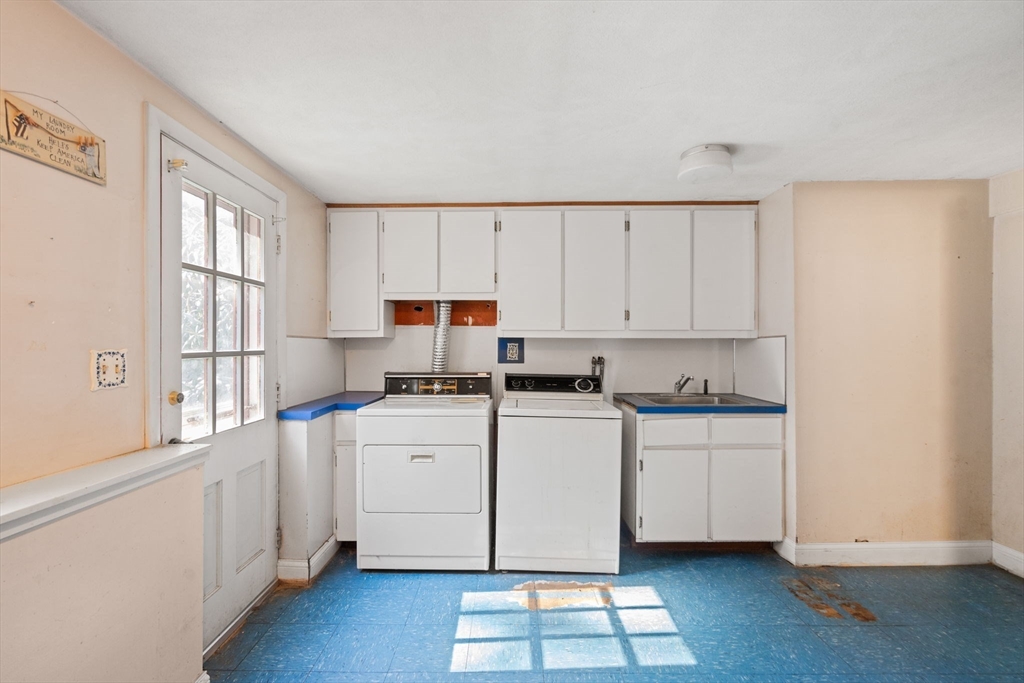 91 Glen Street Natick, MA 01760 - Photo 24 of 39 a kitchen with white cabinets appliances and a window