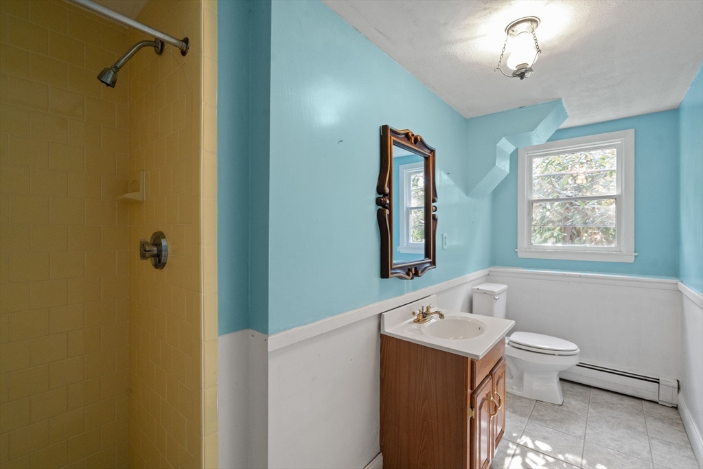 91 Glen Street Natick, MA 01760 - Photo 25 of 39 a bathroom with a sink a toilet and shower