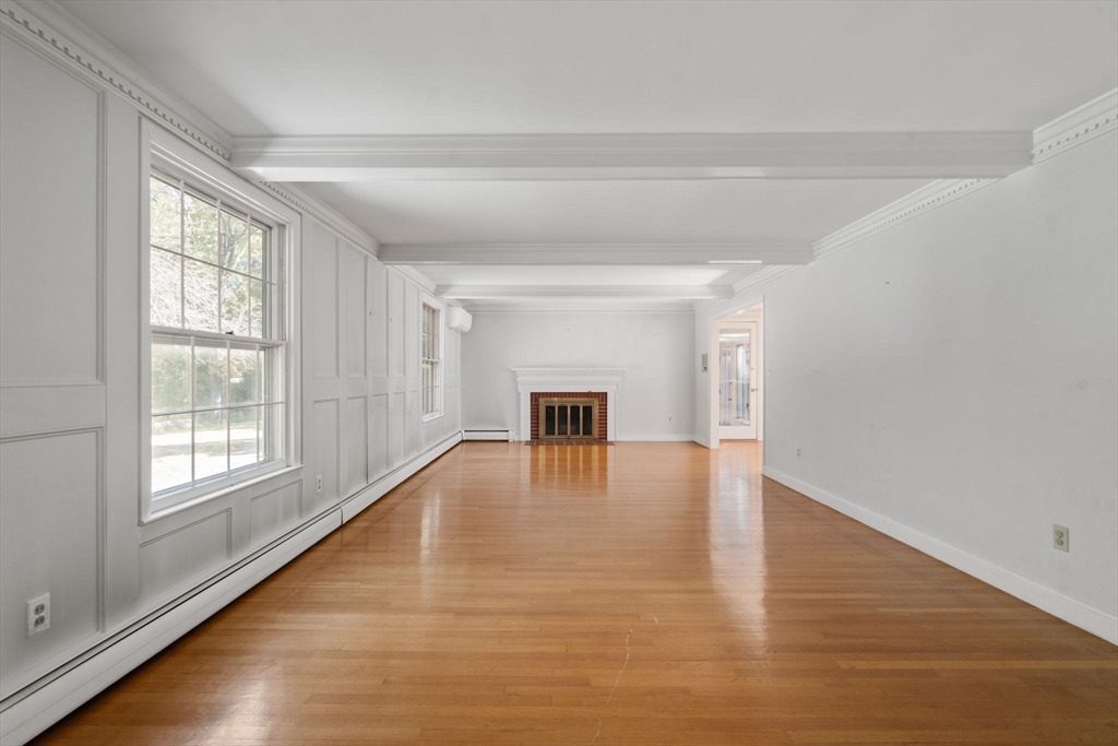 91 Glen Street Natick, MA 01760 - Photo 5 of 39 a view of an empty room with wooden floor and a window