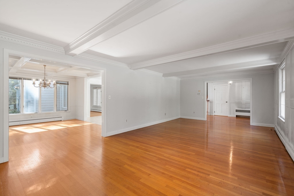 91 Glen Street Natick, MA 01760 - Photo 6 of 39 a view of an empty room with wooden floor and a window