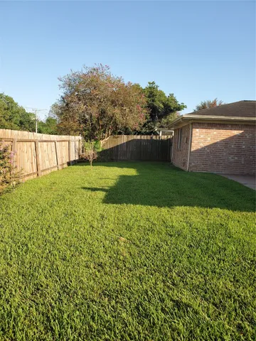 a view of a yard with a house in the background