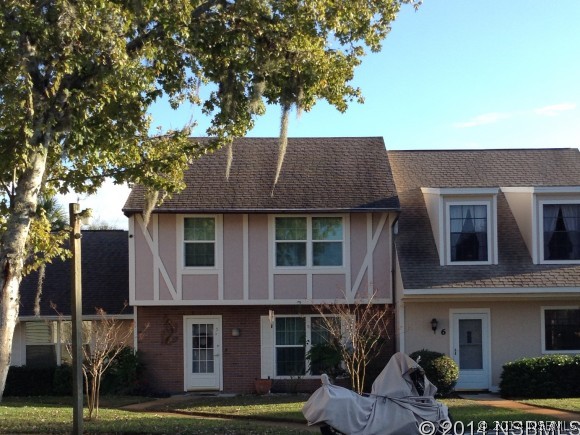 232 North Ridgewood Avenue, Unit A5 Edgewater, FL 32132 - Photo 1 of 15 a front view of a house with a garden