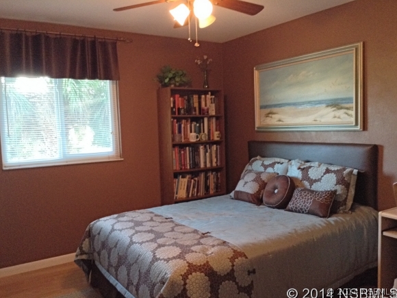 232 North Ridgewood Avenue, Unit A5 Edgewater, FL 32132 - Photo 11 of 15 a bedroom with a bed and a window