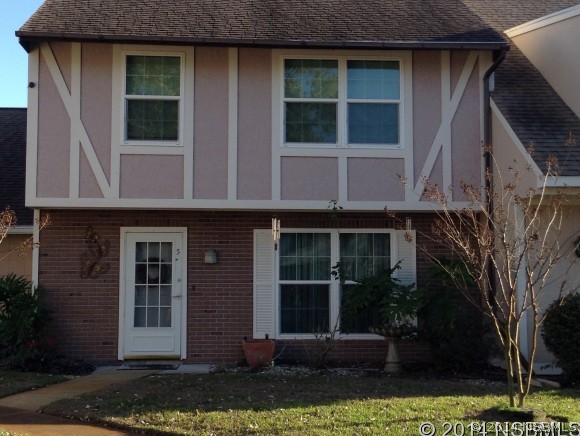 232 North Ridgewood Avenue, Unit A5 Edgewater, FL 32132 - Photo 14 of 15 a front view of a house with garden
