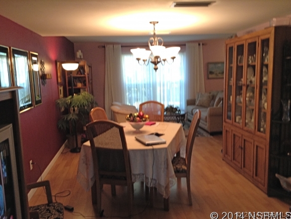 232 North Ridgewood Avenue, Unit A5 Edgewater, FL 32132 - Photo 4 of 15 a view of a dining room with furniture and window