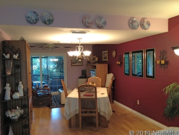 232 North Ridgewood Avenue, Unit A5 Edgewater, FL 32132 - Photo 5 of 15 a dining room with furniture and chandelier