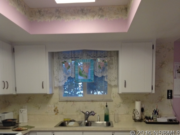 232 North Ridgewood Avenue, Unit A5 Edgewater, FL 32132 - Photo 7 of 15 a kitchen with a sink and cabinets