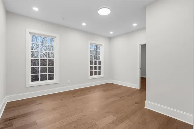 a bathroom with a sink a toilet a mirror a bathtub and shower