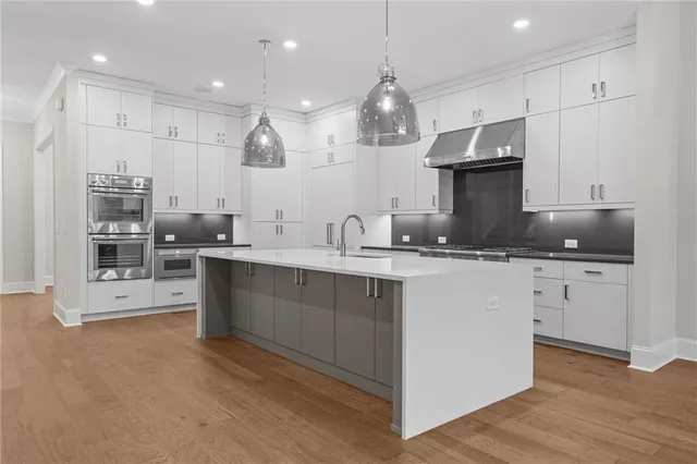 a view of a kitchen with wooden floor and electronic appliances