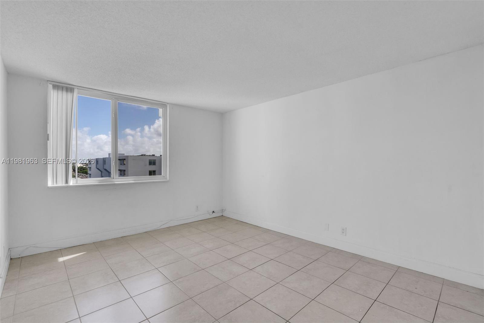 9143 Southwest 77th Avenue, Unit B710 Miami, FL 33156 - Photo 12 of 28 a view of an empty room with a window