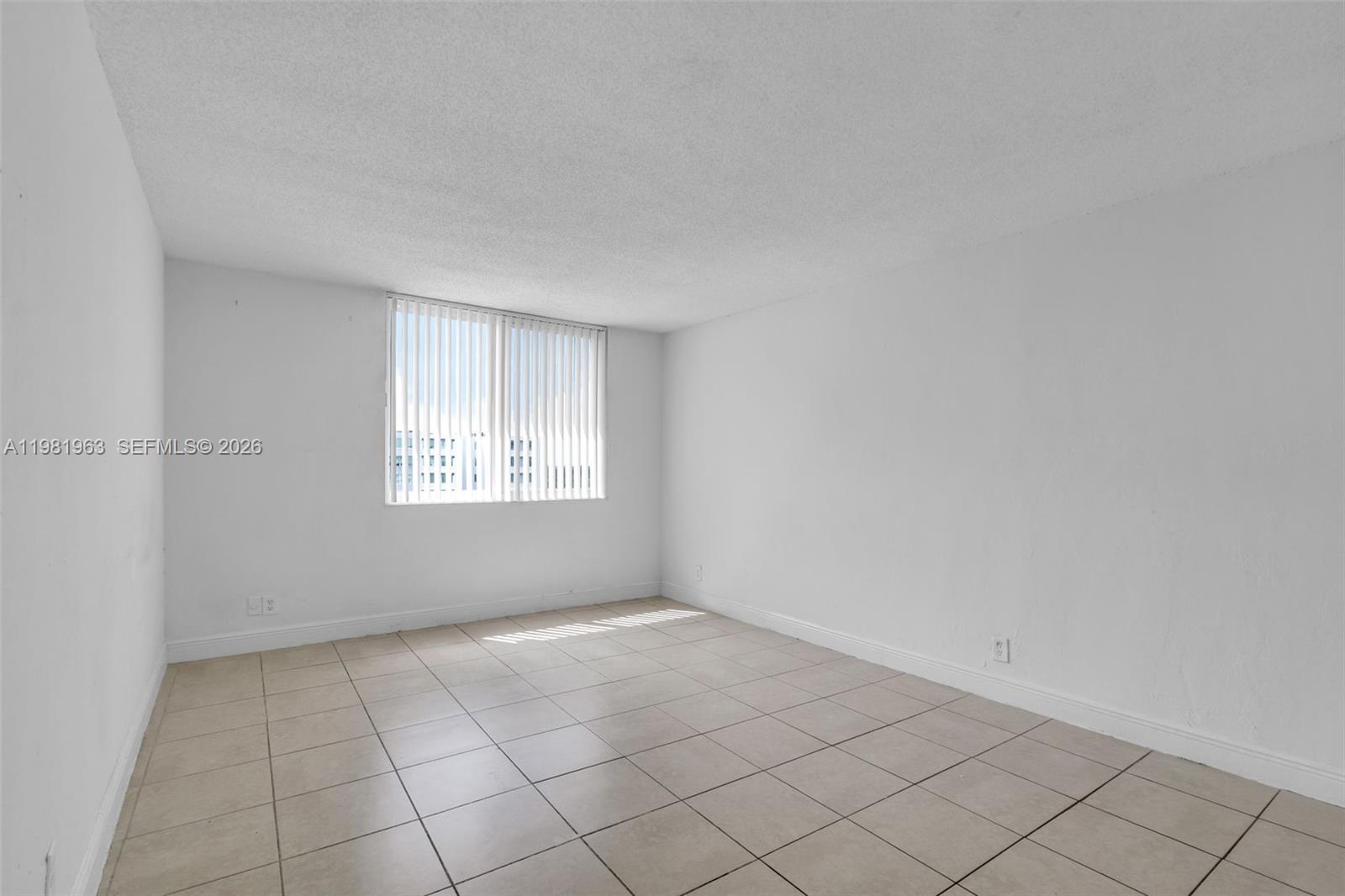 9143 Southwest 77th Avenue, Unit B710 Miami, FL 33156 - Photo 18 of 28 a view of an empty room with a window