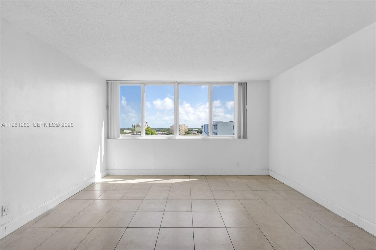 9143 Southwest 77th Avenue, Unit B710 Miami, FL 33156 - Photo 3 of 28 a view of an empty room and window