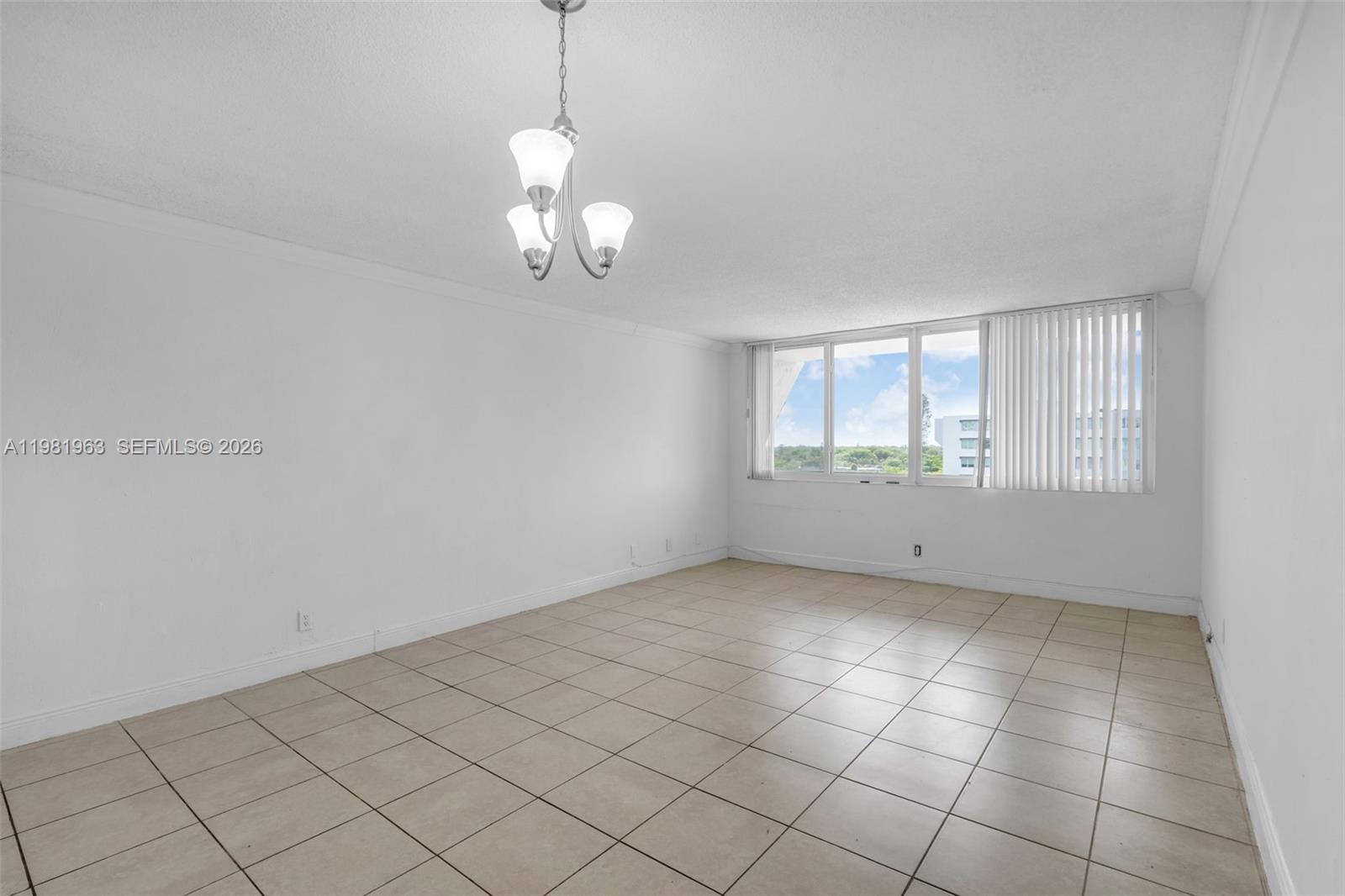 9143 Southwest 77th Avenue, Unit B710 Miami, FL 33156 - Photo 4 of 28 a view of an empty room with a window