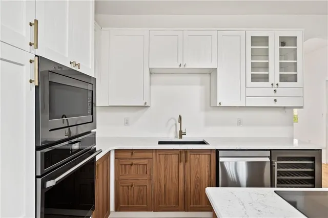 a kitchen with stainless steel appliances and cabinets