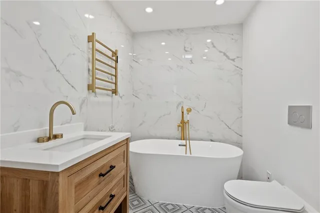 a bathroom with a sink a toilet and a mirror