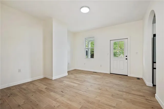 an empty room with windows and closet