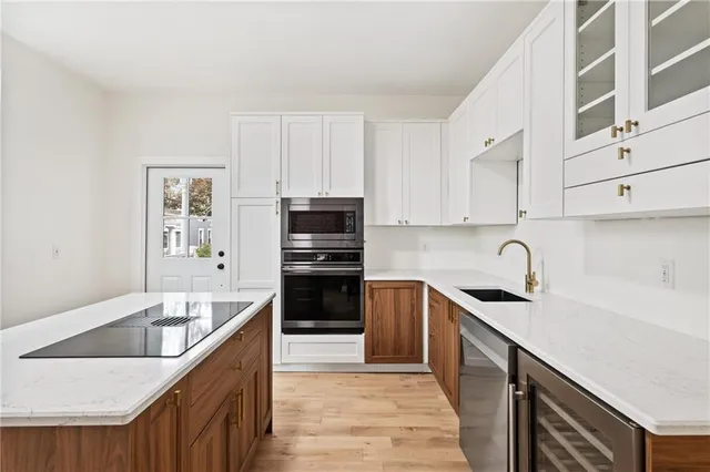 a kitchen with granite countertop a sink and cabinets