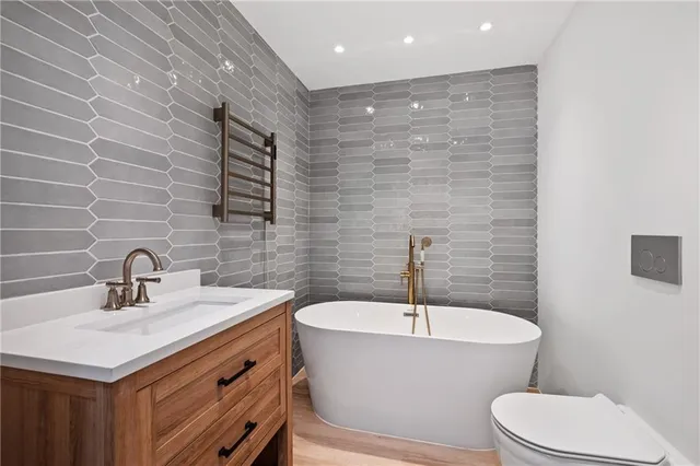 a bathroom with a sink a toilet a mirror and vanity