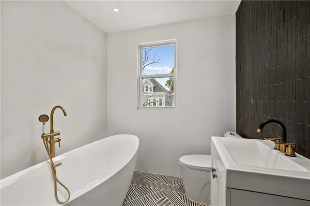 a bathroom with a sink mirror and toilet