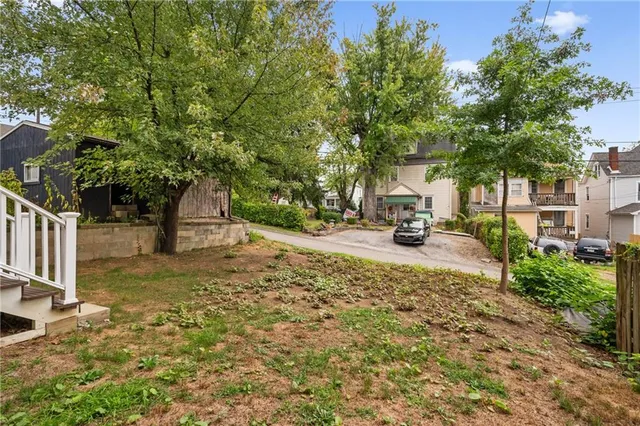 a view of a tree in front of a house