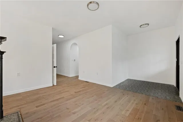 an empty room with wooden floor