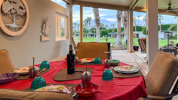 a living room with furniture and a floor to ceiling window