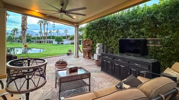 a living room with patio furniture and a yard
