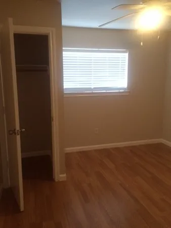 a view of wooden floor and windows in a room