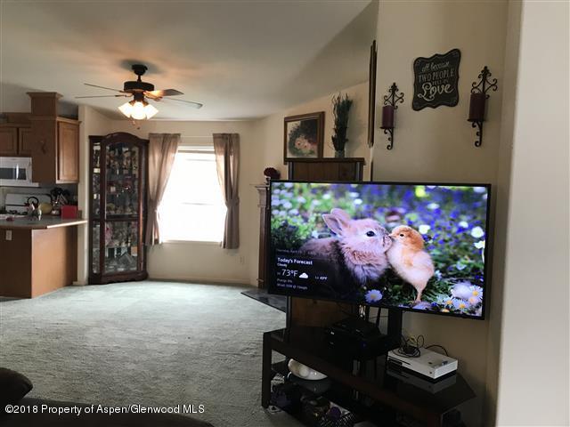 200 West 20th Street, Unit D4 Rifle, CO 81650 - Photo 6 of 23 a living room with furniture and a flat screen tv
