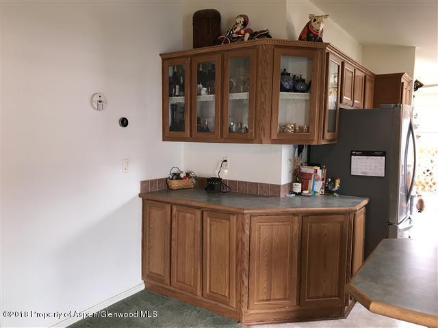 200 West 20th Street, Unit D4 Rifle, CO 81650 - Photo 8 of 23 a kitchen with stainless steel appliances granite countertop a sink stove and cabinets