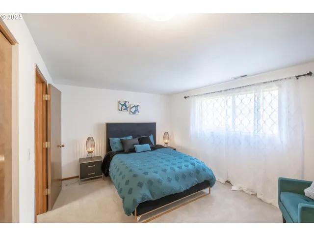 a bedroom with a bed and a window