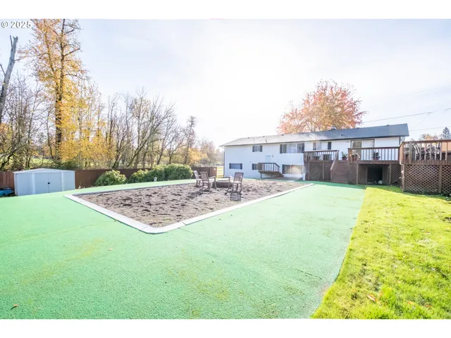 a view of a house with backyard and sitting area