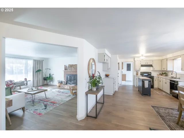 a living room with furniture and view of kitchen