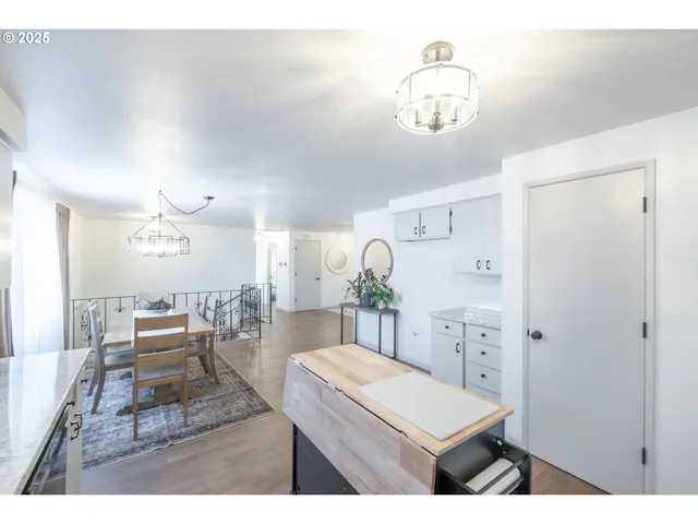 a living room with furniture a chandelier and a window