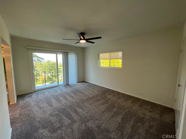 a view of a livingroom with a ceiling fan and window
