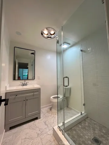 a view of a big room with wooden floor and windows