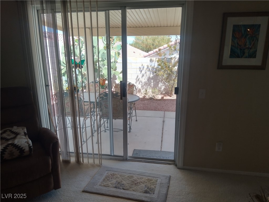 2148 Hidden Ranch Terrace Henderson, NV 89052 - Photo 6 of 31 Doorway to outside featuring carpet floors and a wealth of natural light
