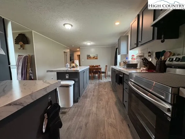 a kitchen with a sink appliances and cabinets