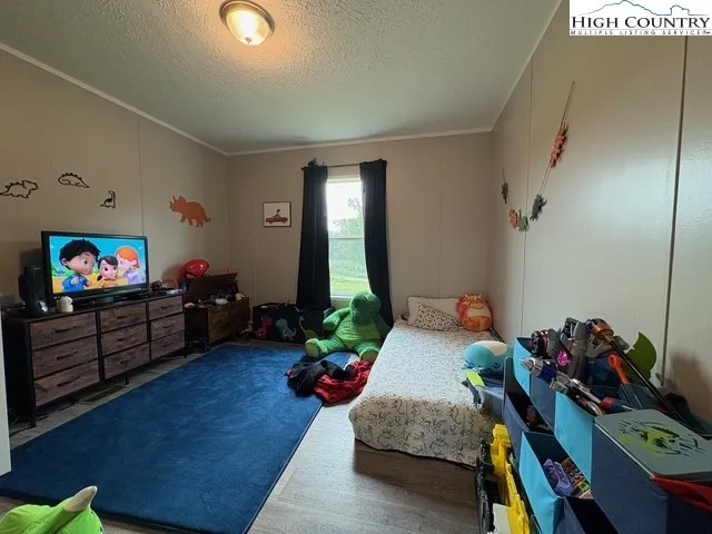 a bedroom with furniture and a wooden floor