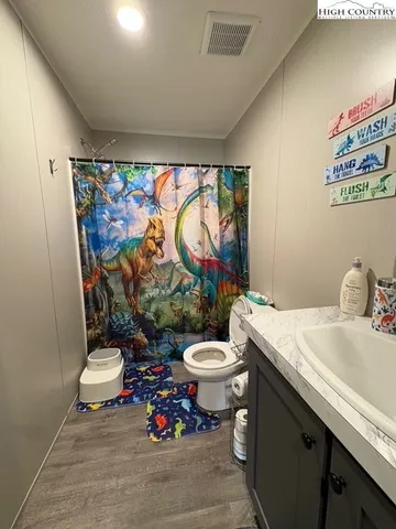 a bedroom with a bed and flat screen tv