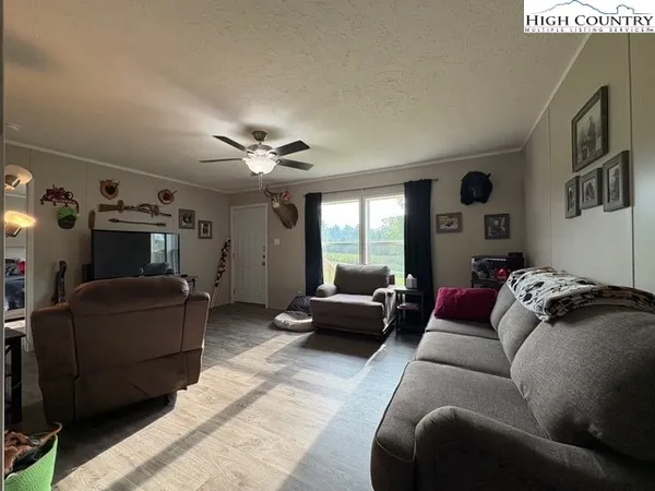 a living room with furniture and a chandelier