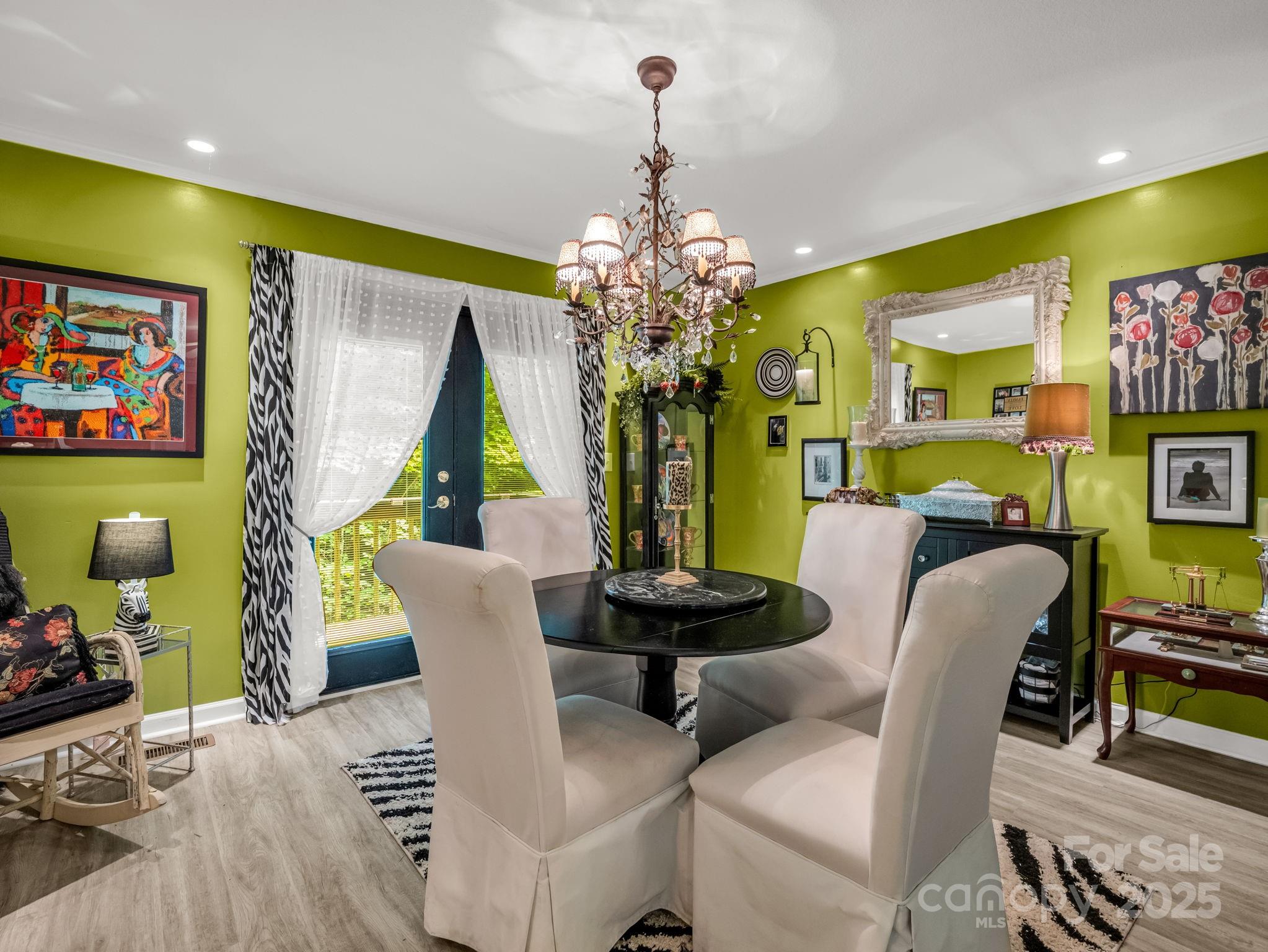 134 Downing Place Lake Lure, NC 28746 - Photo 12 of 35 a view of a dining room with furniture and a chandelier