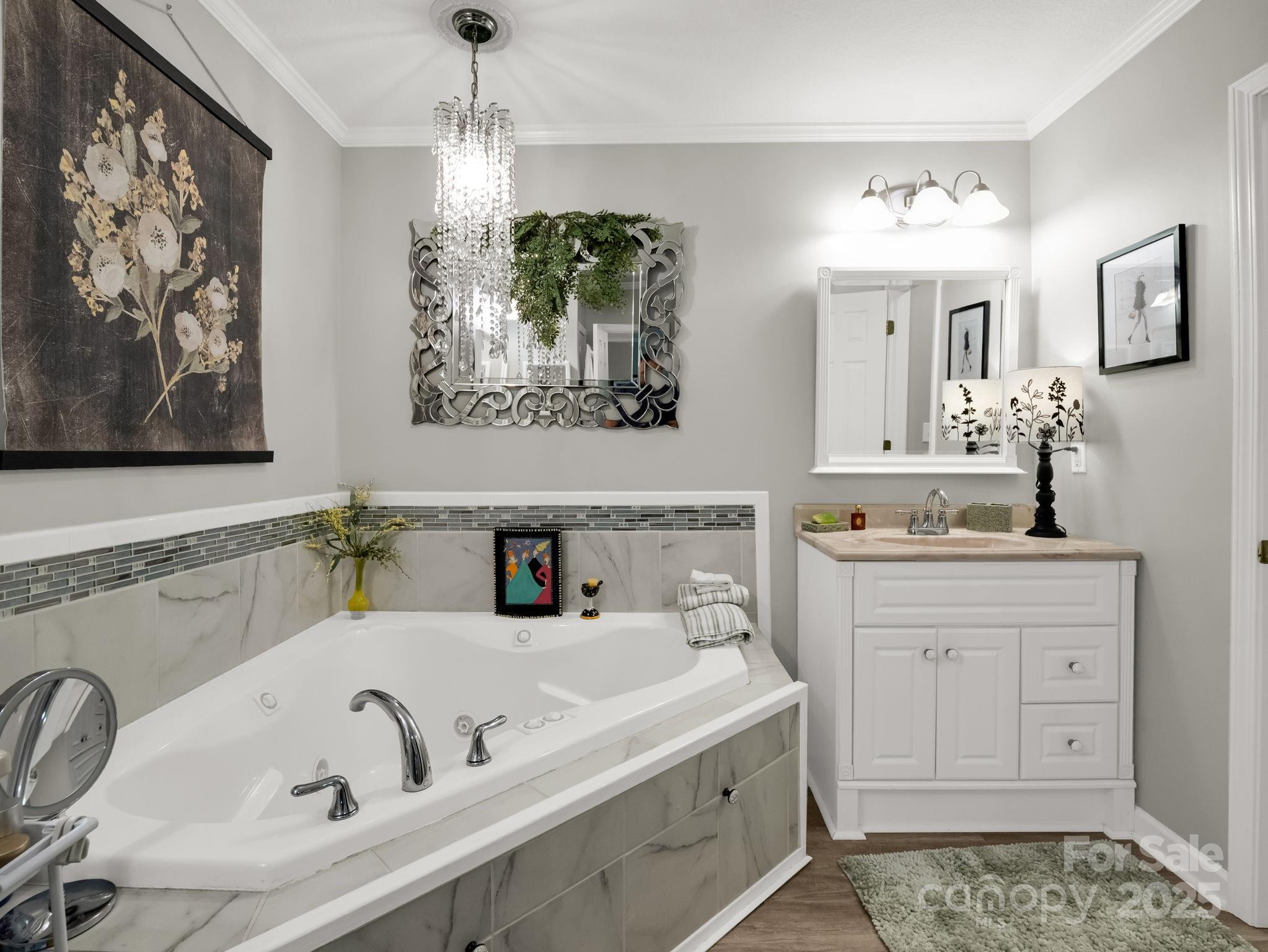 134 Downing Place Lake Lure, NC 28746 - Photo 19 of 35 a bathroom with a tub sink and mirror
